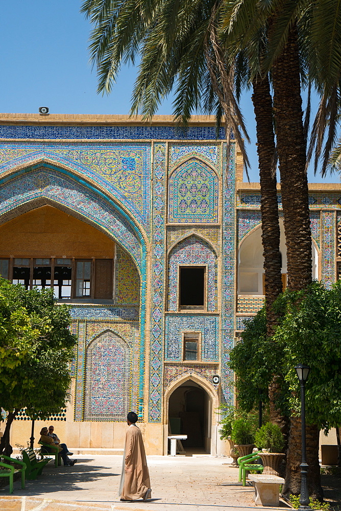 Mullah crossing the courtyard of Madraseh-ye Khan, Shiraz, Iran, Middle East