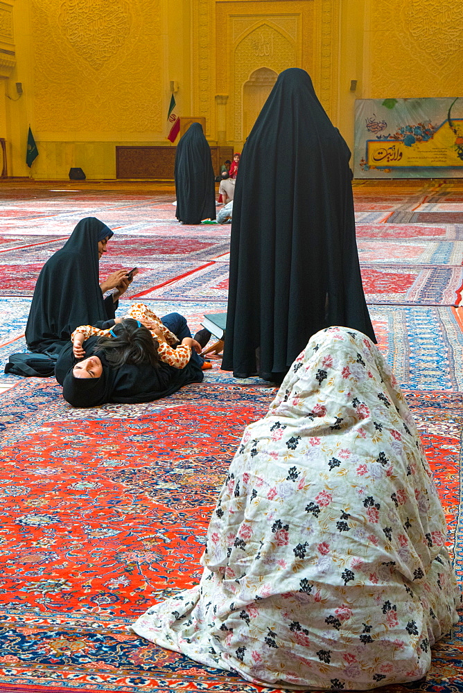 Women and child gathered, interior, Aramgah-e Shah-e Cheragh (Mausoleum of the King of Light), Shiraz, Iran, Middle East