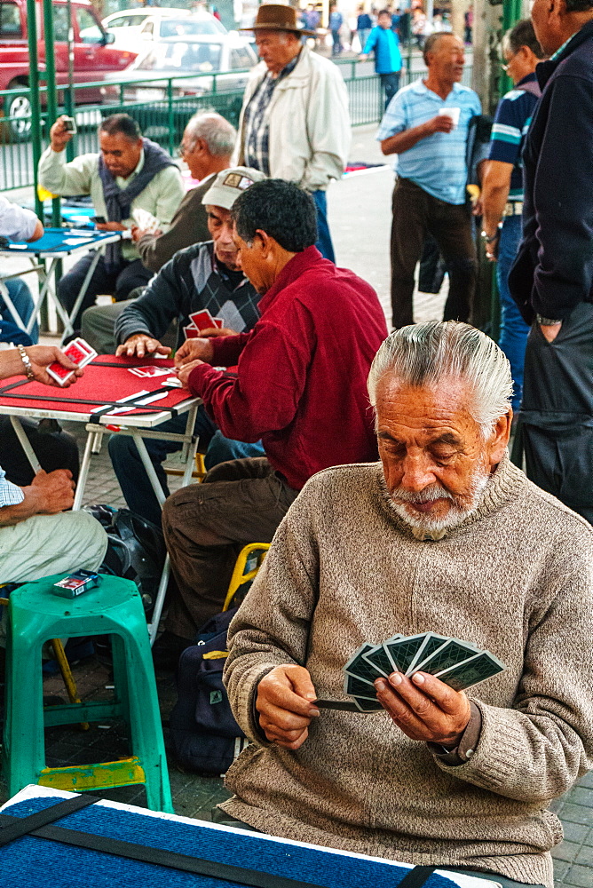 Card players gather out in public by the main bus station, Valparaiso, Chile, South America