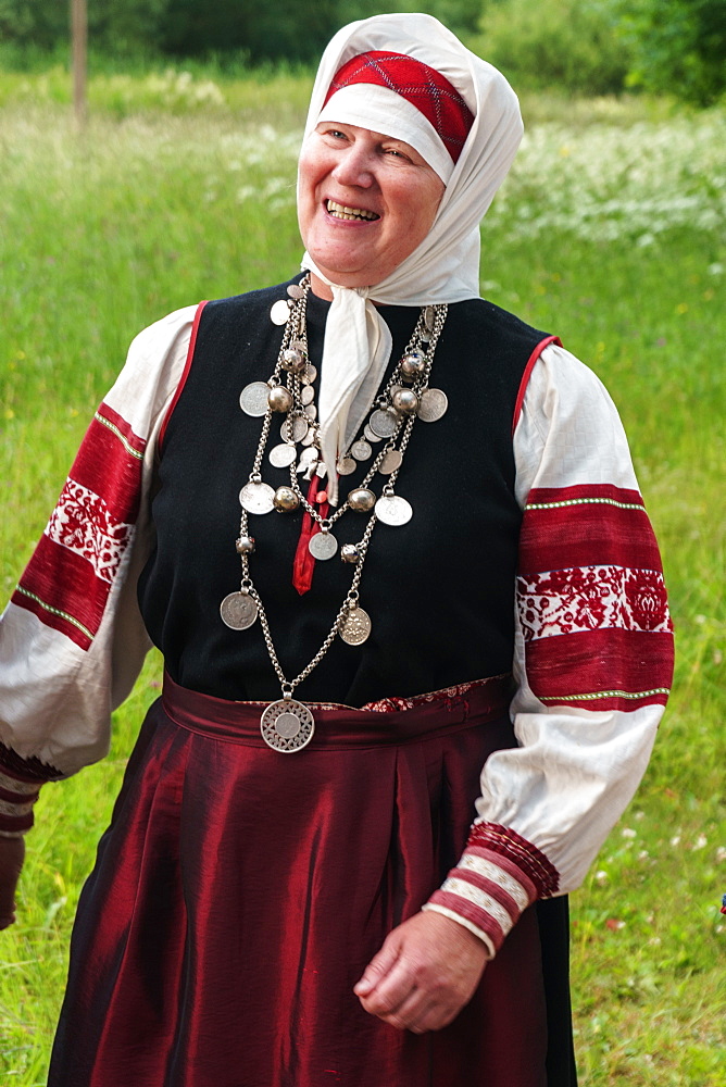 Mature Seto woman, singing polyphonically at Feast Day of St. Peter and St. Paul, Uusvada, Setomaa, SE Estonia, Europe