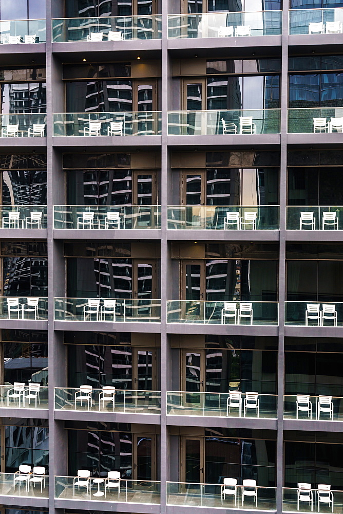 Uniform and soulless apartment blocks with two empty white chairs on each balcony, Manila, Philippines, Southeast Asia, Asia