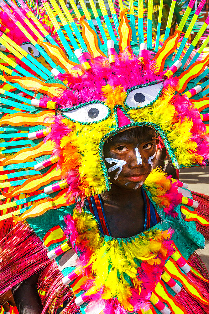 Participant in flamboyant dress, eyes matching those on his costume, at the annual Ati-Atihan Festival, Kalibo Island, Philippines, Southeast Asia, Asia