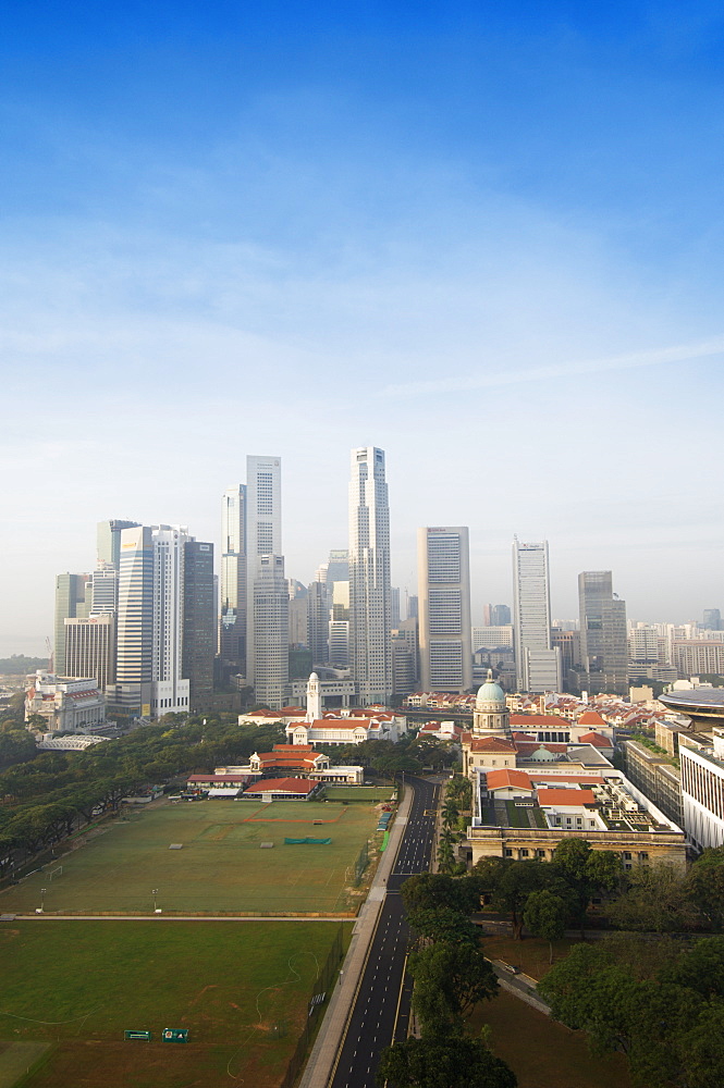 Singapore city skyline at dawn with the Padang and Colonial District in the foreground, Singapore, Southeast Asia, Asia