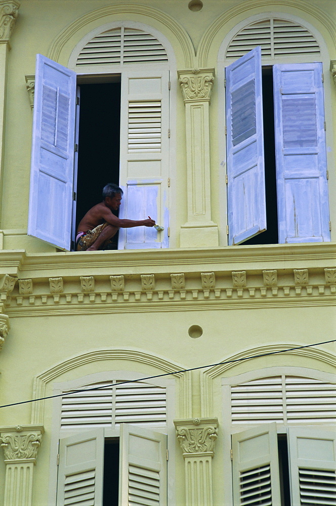 Man painting shutters on a house, Chinatown, Singapore, Asia