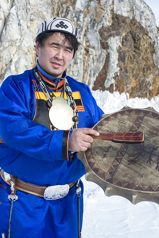 Hereditary Buryat shaman, Valentin Khagdaev with skin covered drum at Olkhon Island celebrating the spirit of Baikal on the ice, Lake Baikal, Irkutsk Oblast, Siberia, Russia, Eurasia