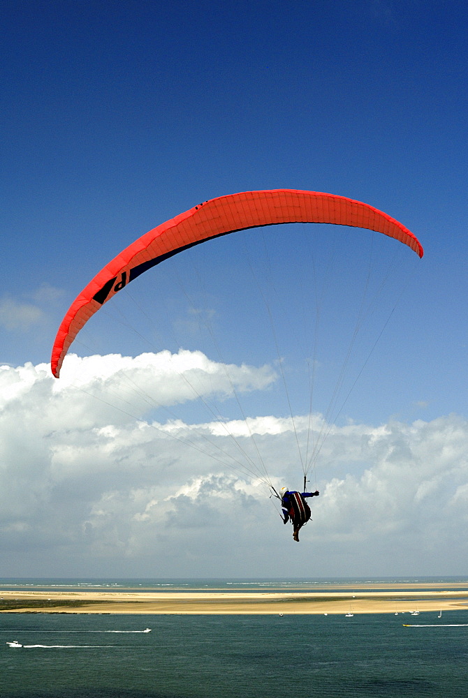 Red hang glider over Bay of Arcachon, Gironde, Aquitaine, France, Europe