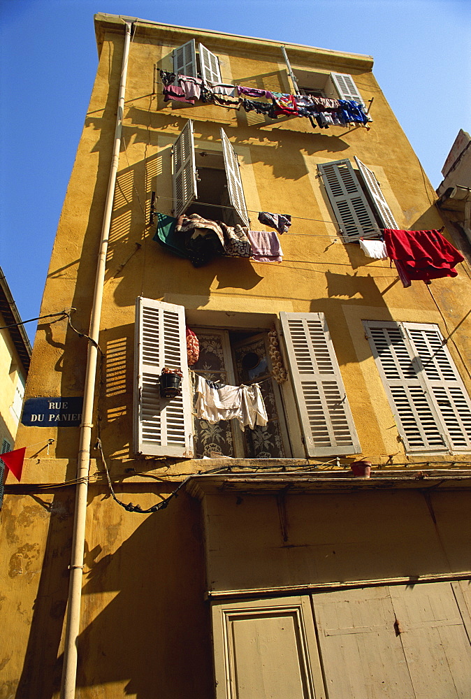 House with shutters and washing lines on the Rue du Panier, in the old town in Marseille, Bouches du Rhone, Provence, France, Europe