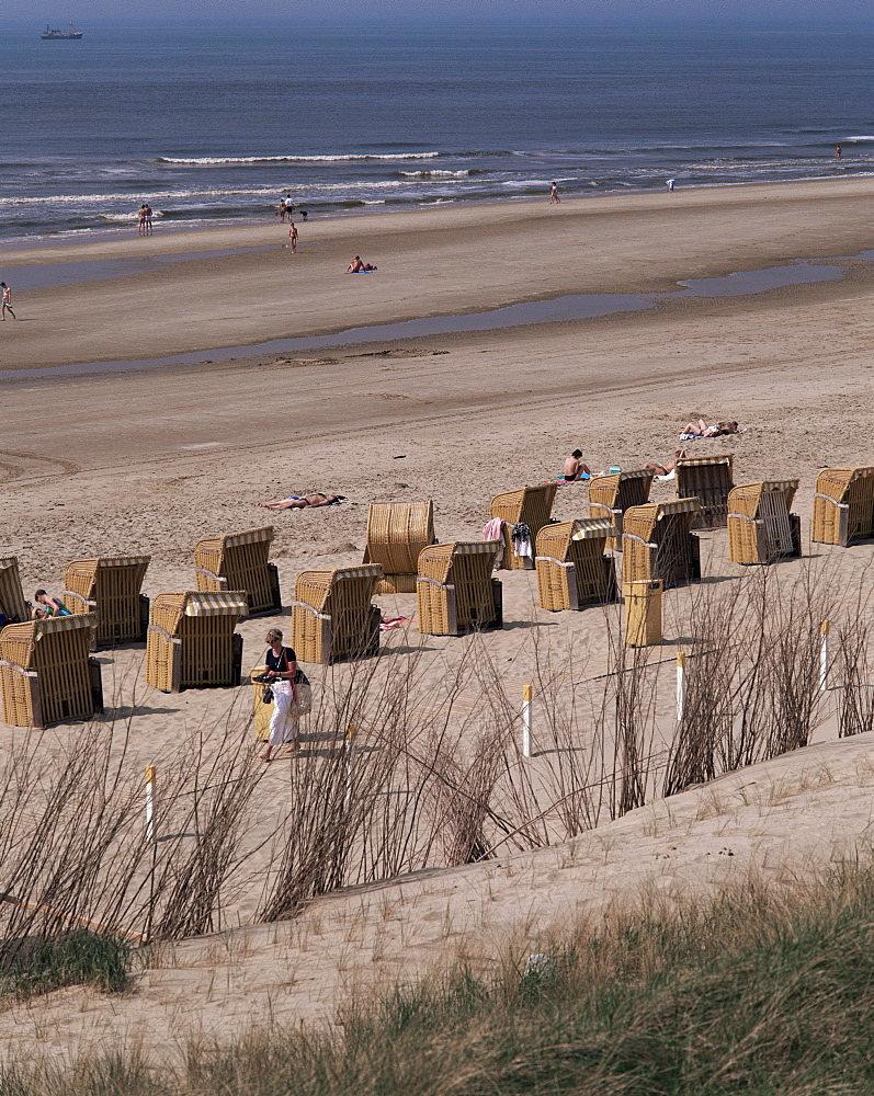 Cane chairs on beach, Egmond, Holland, Europe