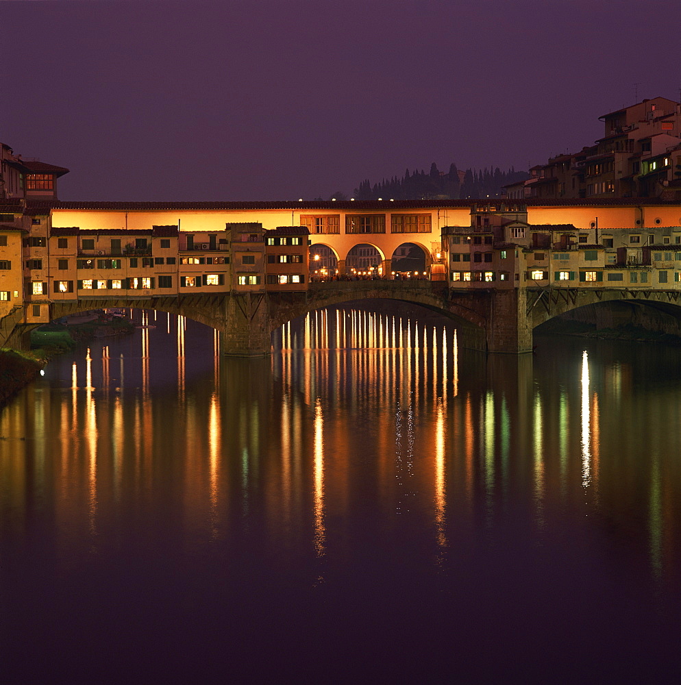 Reflections in the River Arno of lights on the Ponte Vecchio bridge at dusk in the town of Florence, UNESCO World Heritage Site, Tuscany, Italy, Europe