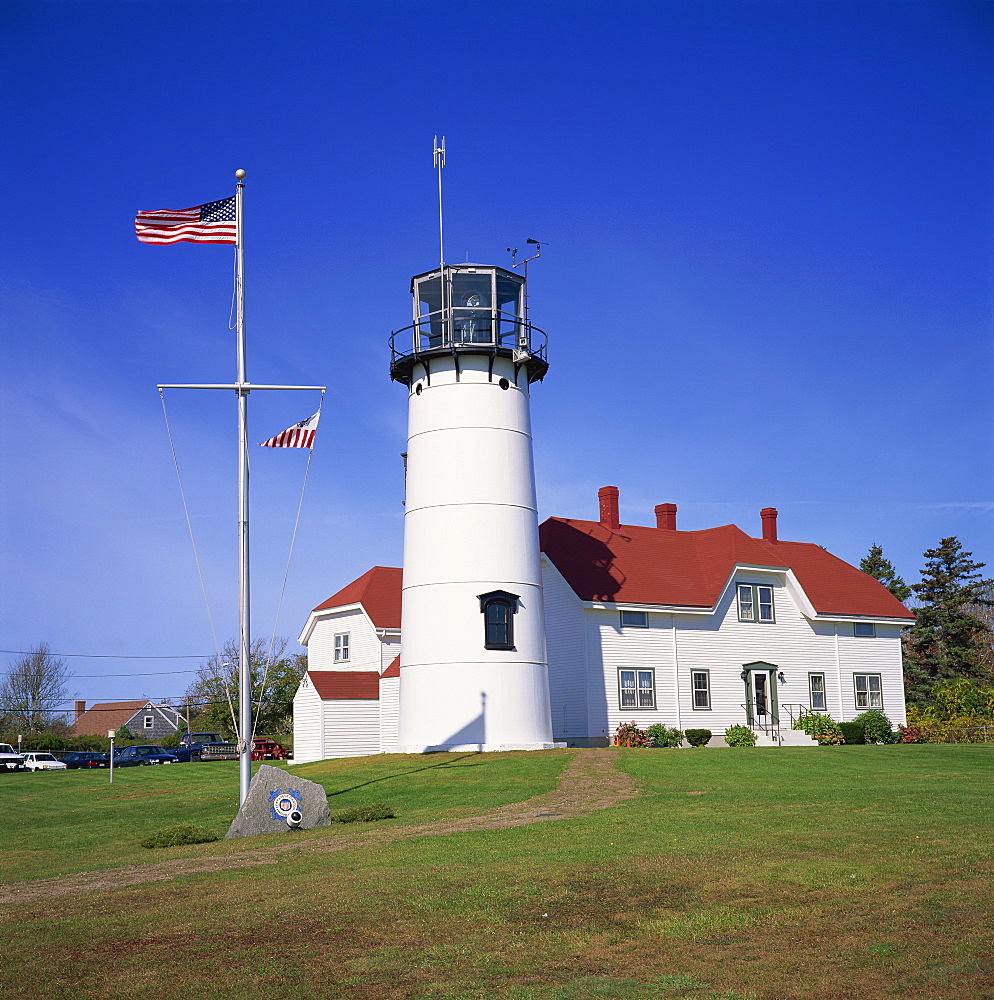 The American flag flying beside the Chatham lighthouse at Cape Cod, Massachusetts, New England, United States of America, North America