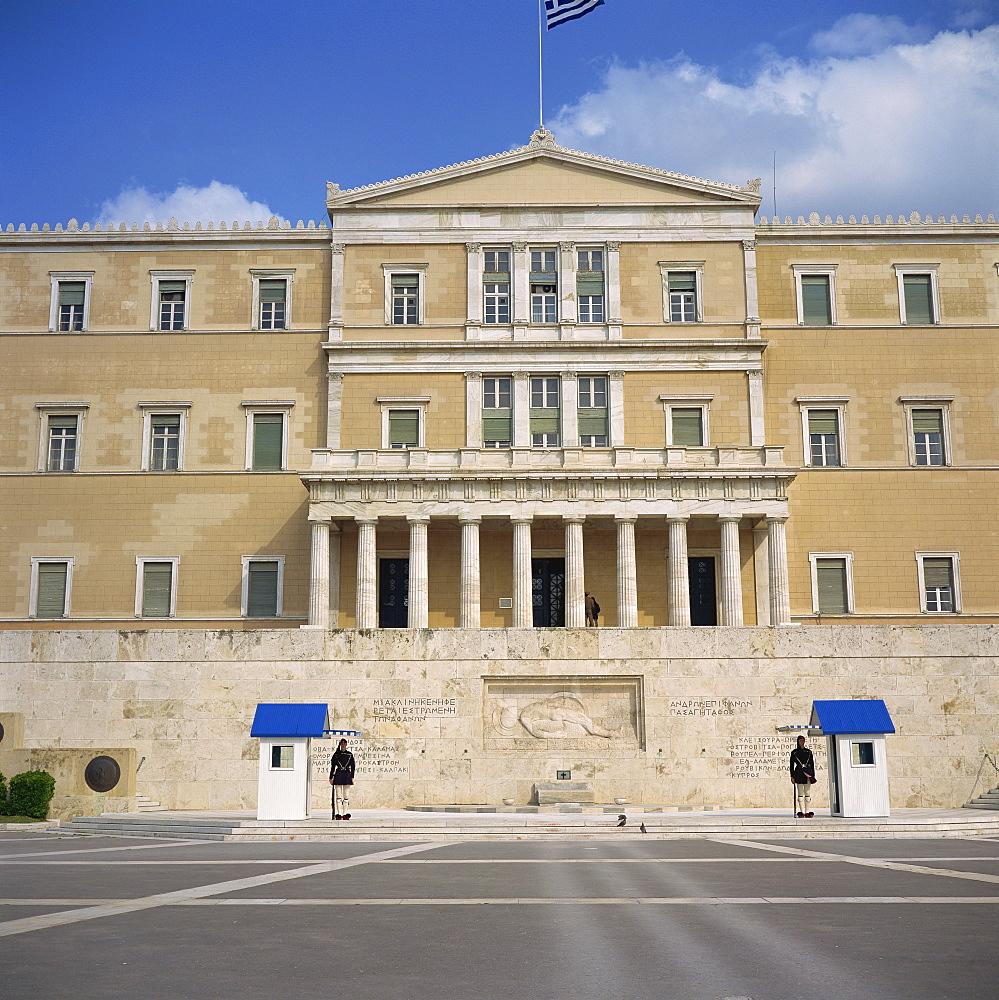 Guards in front of the Tomb of the Unknown Soldier with the old Palace Parliament behind in Athens, Greece, Europe