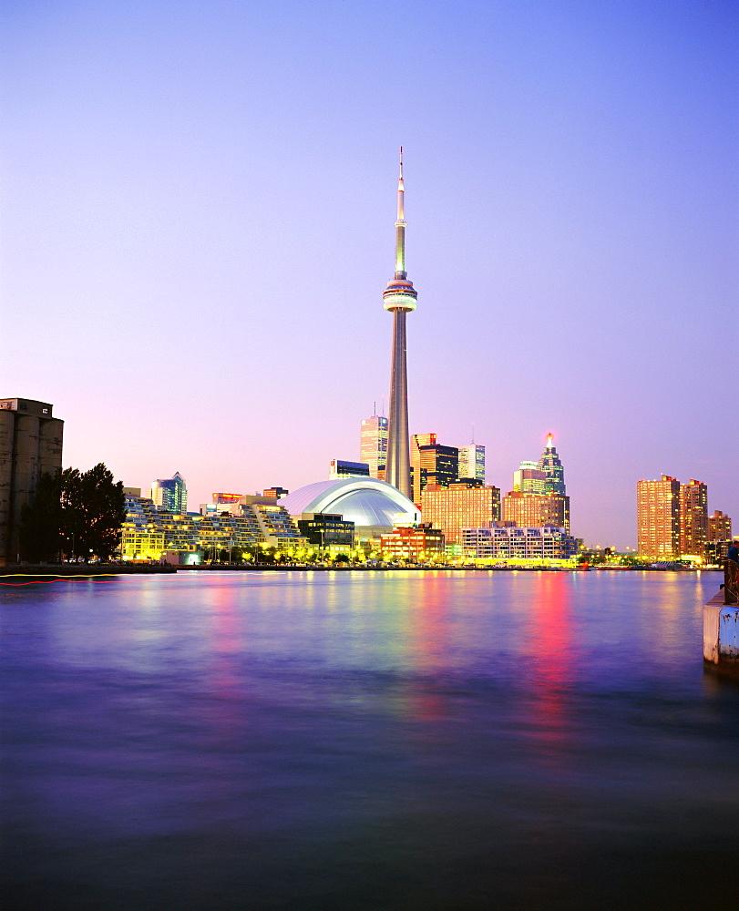 The CN tower rises above the city skyline at dusk, Toronto, Ontario, Canada