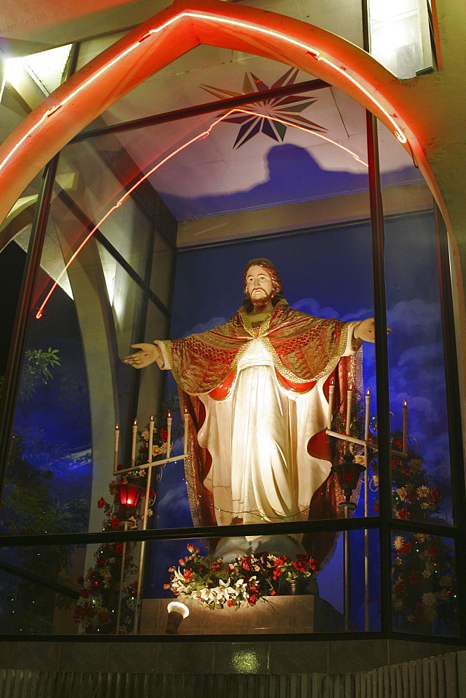 Christian shrine of Jesus on roadside near Colombo at night, Sri Lanka, Asia