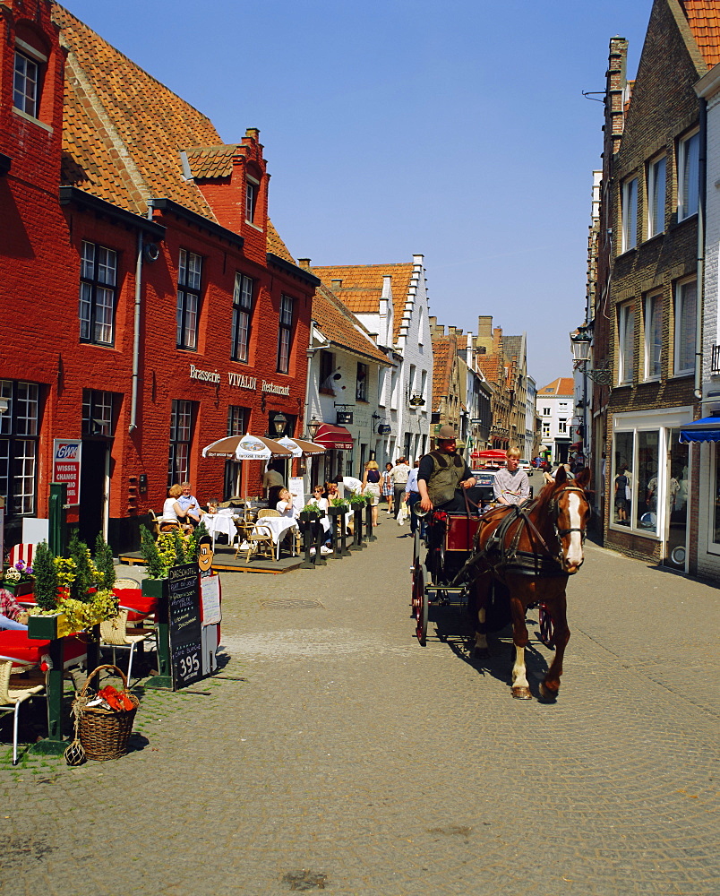 Horse and trap on cobbled streets and cafes, Bruges, Belgium