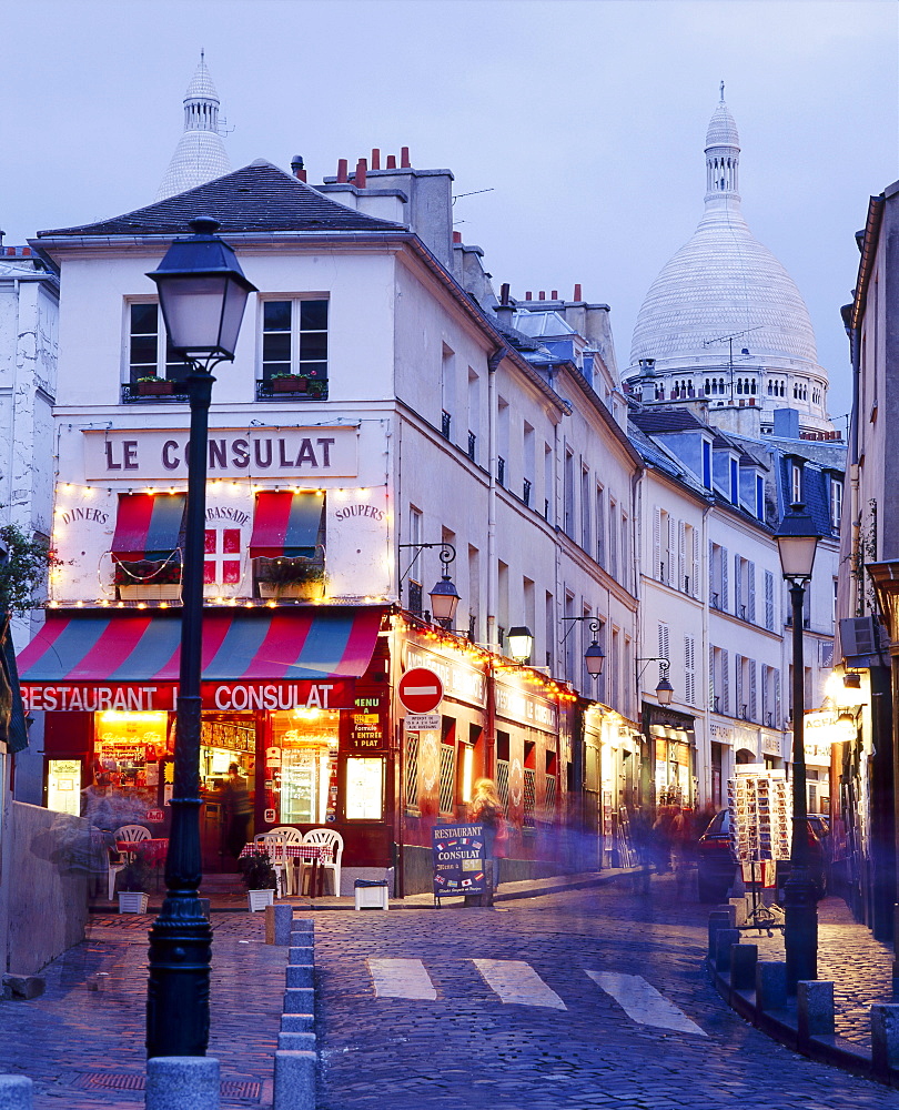 Montmartre street scene and the dome of the Sacre Cour, Paris, France 