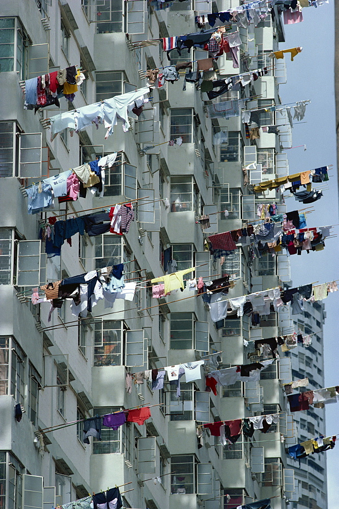 Close-up of washing hanging from bamboo poles outside a block of apartments in Singapore, Southeast Asia, Asia