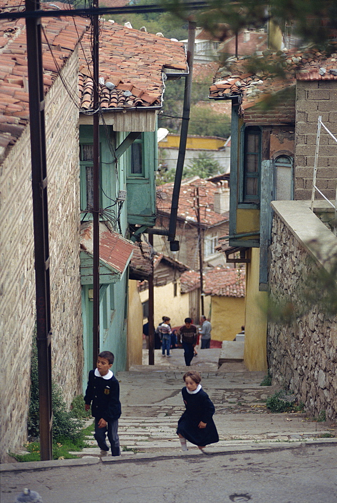 Children climb steps in a narrow street in the town of Bursa, Anatolia, Turkey, Asia Minor, Eurasia