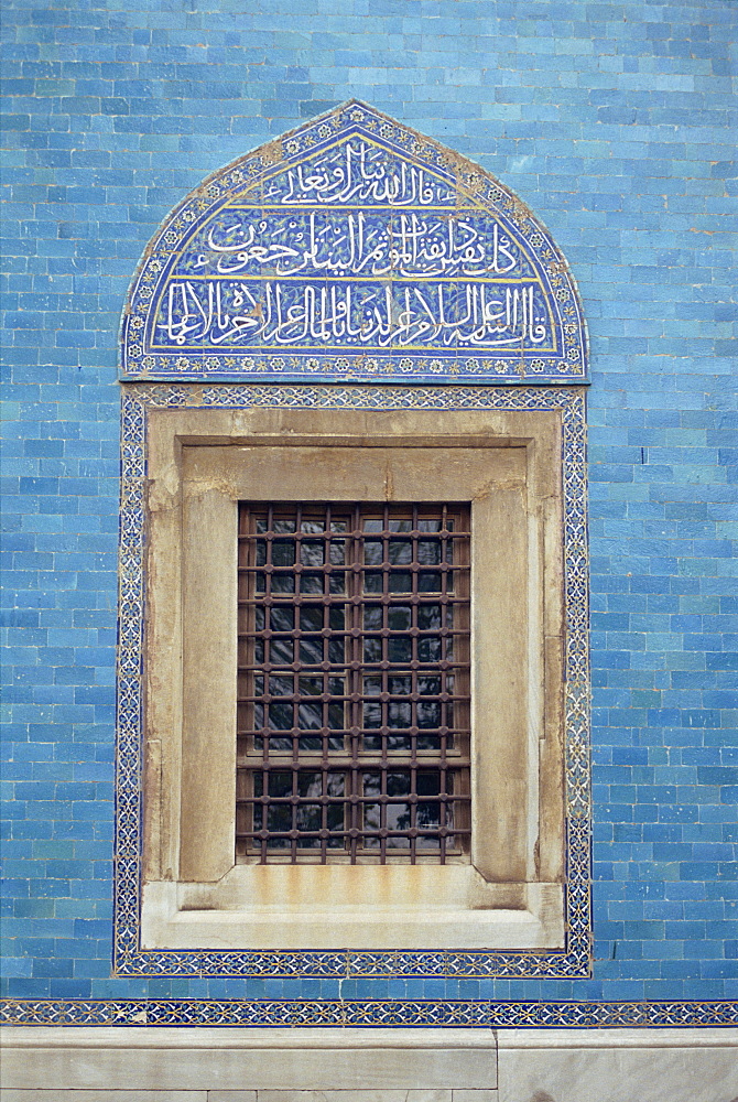 Detail of window with Arabic script on tilework above, in the Green Mosque in Bursa, Anatolia, Turkey, Asia Minor, Eurasia