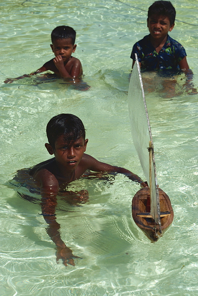 Boys with toy boat, Maldive Islands, Indian Ocean, Asia