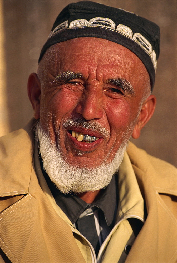 Portrait of an old Uzbek man with crooked and metal teeth smiling, in Khiva, Uzbekistan, Central Asia, Asia