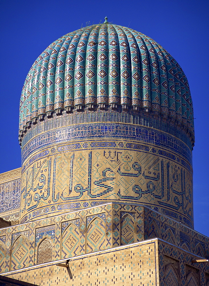 The ribbed dome, tiles and Arabic script on the Bibi Khanym Mosque in Samarkand, Uzbekistan, Central Asia, Asia