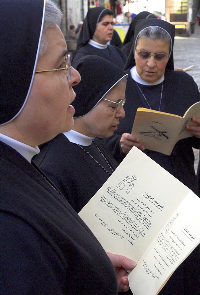 Group of Palestinian nuns praying on Good Friday at the Third Station of the Cross, Via Dolorosa, Old City, Jerusalem, Israel, Middle East