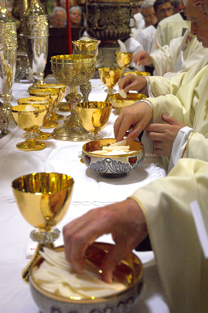 Close-up of priests' hands taking the host during Mass in Easter week celebrated by Monseigneur Fouad Boutros Tawal, Coadjutor of the Latin Patriarch of Jerusalem, Church of the Holy Sepulchre, Old City, Jerusalem, Israel, Middle East