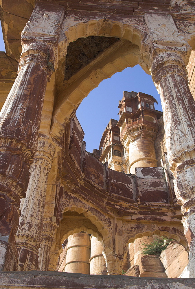 Palace towers of Meherangarh fort seen through remains of a stone temple, Jodhpur, Rajasthan state, India, Asia