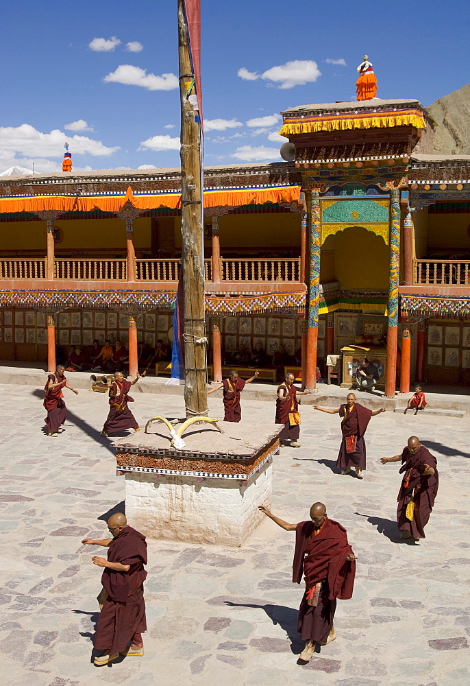 Group of monks dancing in the monastery courtyard rehearsing for Hemis festival, Hemis, Ladakh, India, Asia