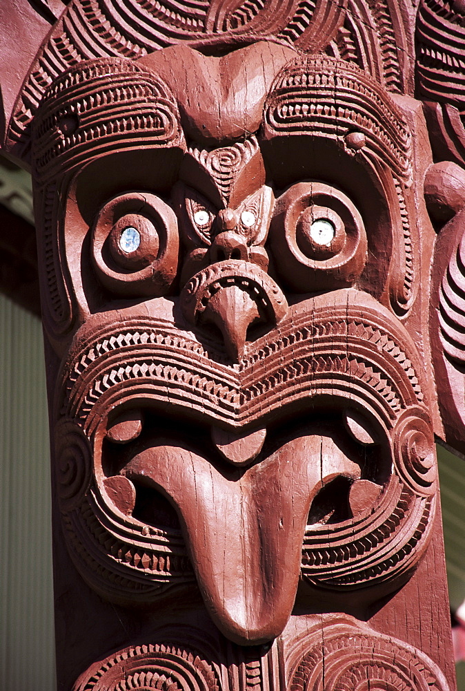 Maori wooden carving with tongue sticking out, Rotorua, North Island, New Zealand, Pacific