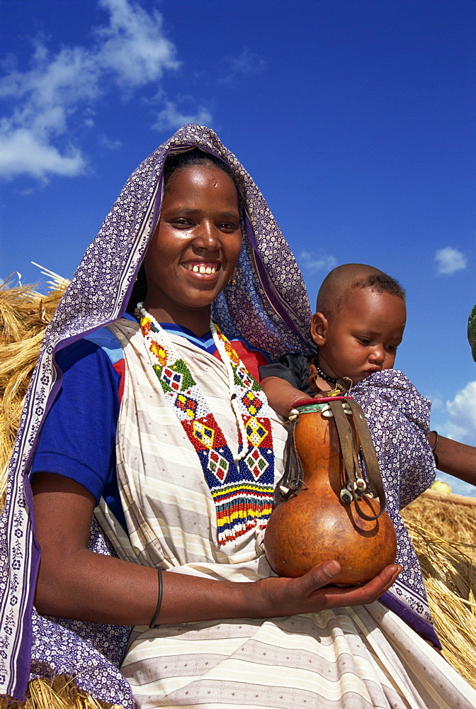 Mother holding baby and gourd, Ethiopia, Africa