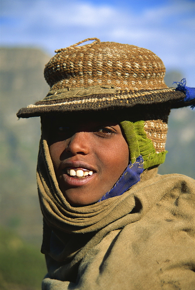 Smiling hill tribe boy with hand woven hat, Simien Mountains, Ethiopia, Africa