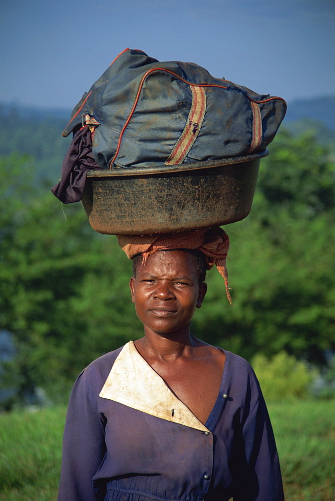 Woman carrying washing on her head, Uganda, East Africa, Africa