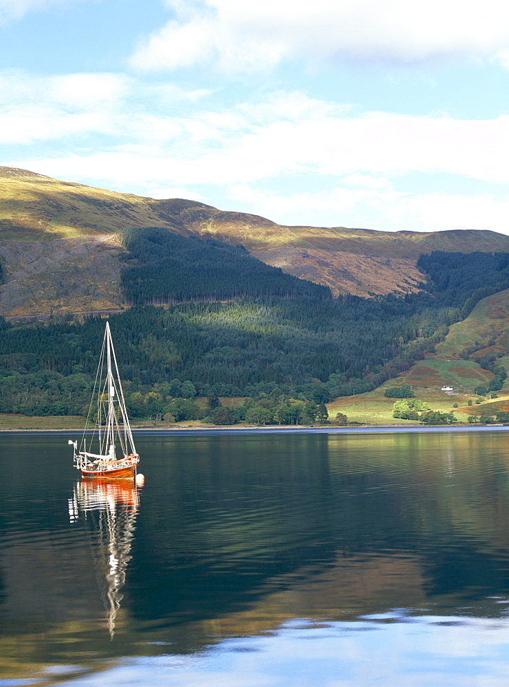 Wooden yacht on Loch Leven, in autumn, Glencoe, Highland region, Scotland, United Kingdom, Europe