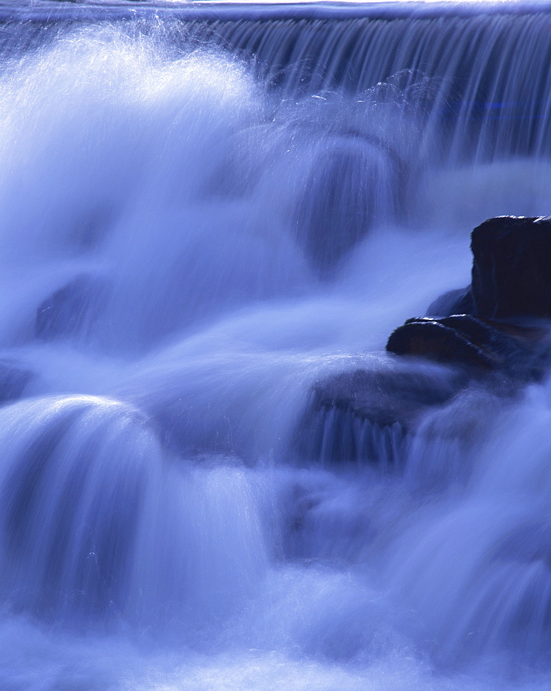 Close-up of waterfall, water cascading over rocks in the Highlands of Scotland, United Kingdom, Europe