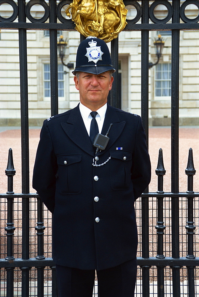 Portrait of a policeman standing outside Buckingham Palace, looking at the camera, London, England, United Kingdom, Europe