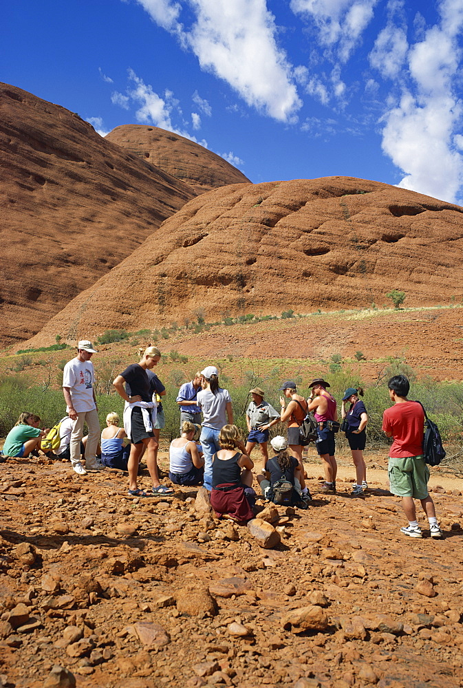 A group of tourists trekking in the Valley of the Winds in the Olgas, in Northern Territory, Australia, Pacific