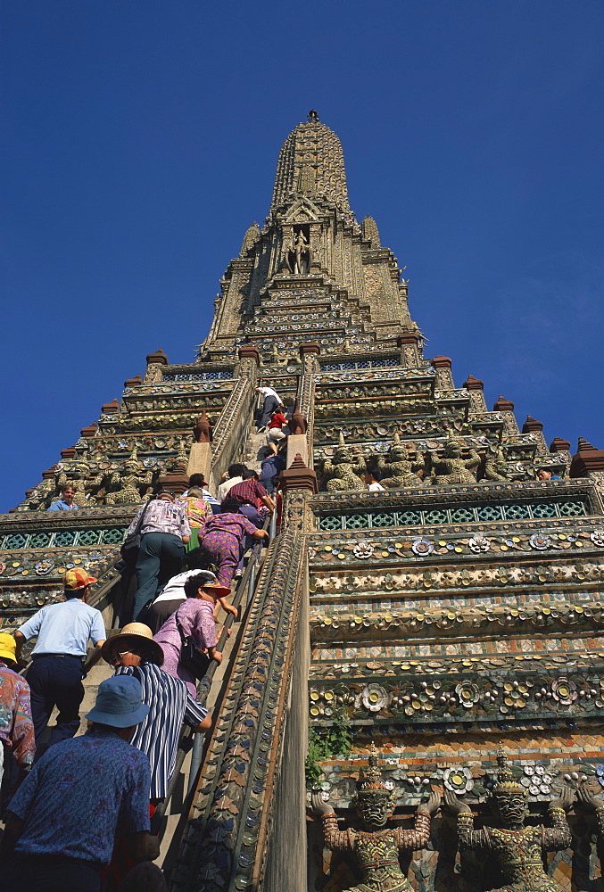 Tourists climb the steps of Wat Arun (Temple of the Dawn), in Bangkok, Thailand, Southeast Asia, Asia