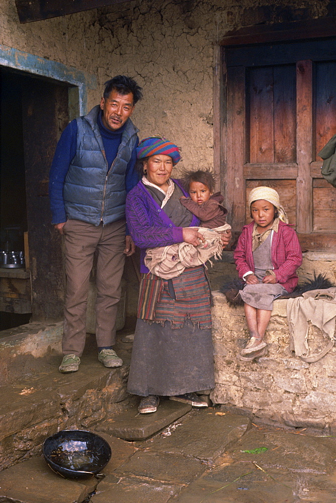 Portrait of a Nepali family at the Lang Maya teahouse in the Taktor King area of Solu Khumbu, Nepal, Asia