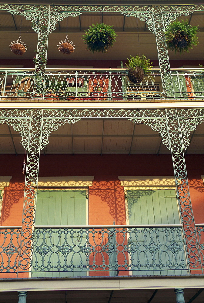 Detail of wrought iron and wooden shutters on balconies of buildings in the French Quarter of New Orleans, Louisiana, United States of America, North America