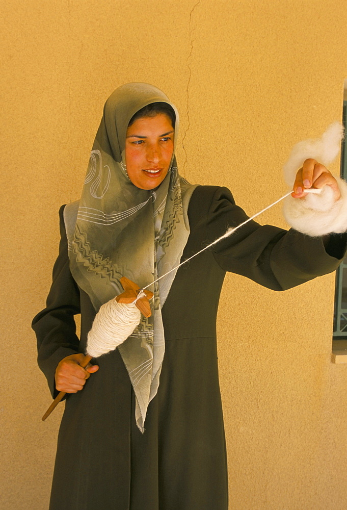 A young woman spinning wool at the Bani Hamida Project, Jordan River Foundation, Najed, Jordan, Middle East