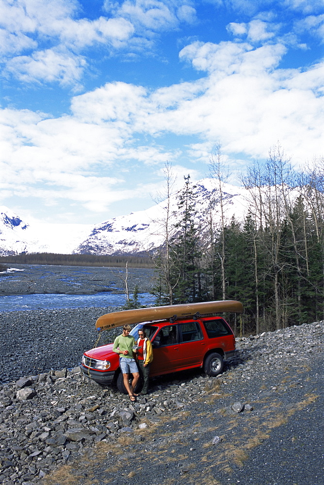 Couple with canoe checking their map at Exit Glacier, off Seward Highway, Seward, Alaska, United States of America, North America