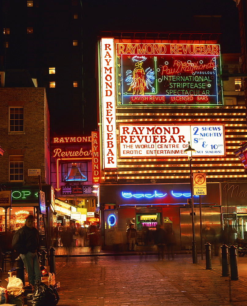 The Raymond Revuebar with neon signs in red light area at night, Soho, London, England, United Kingdom, Europe