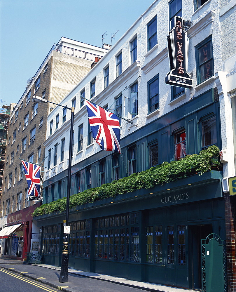 Exterior of Quo Vadis bar and restaurant, Union flags flying, Soho, London, England, United Kingdom, Europe