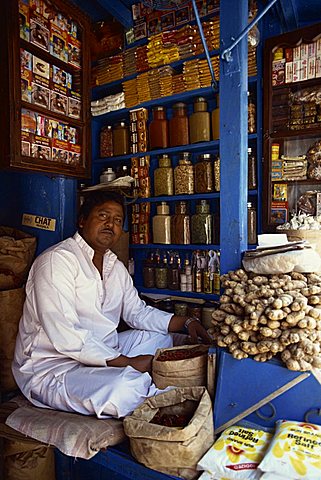 Portrait of an Indian shopkeeper selling ginger root and spices in his shop in Kolkata (Calcutta), West Bengal, India, Asia