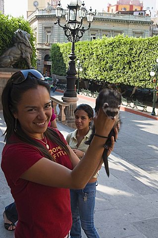 Girl with ferret, Guanajuato, Guanajuato State, Mexico, North America