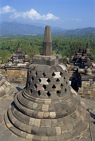 View over surrounding landscape from behind a bell (pagoda) structure on the Buddhist monument, Borobudur, UNESCO World Heritage Site, Java, Indonesia, Southeast Asia, Asia