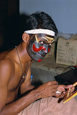 Kathakali dancer applying make-up, Kerala state, India, Asia