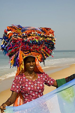 Local vendor selling beach clothing on beach near the Leela Hotel, Mobor, Goa, India, Asia