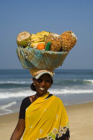 Fruit vendor on beach near the Leela Hotel, Mobor, Goa, India, Asia